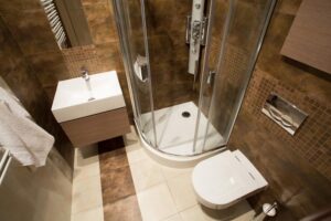 Luxurious bathroom with spotless, elegant brown tiled walls and modern fixtures.