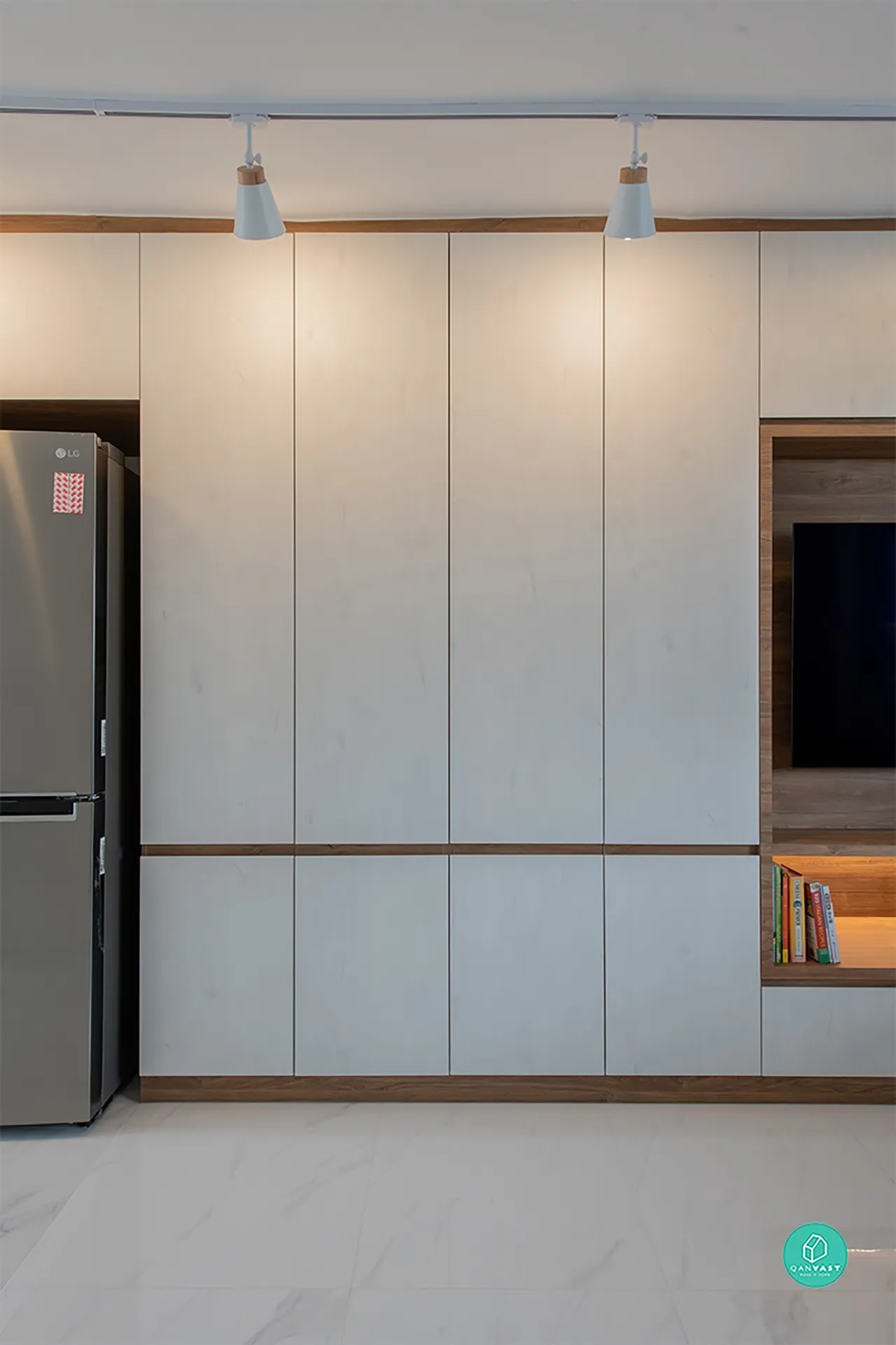 Integrated living room and media wall in 4-room HDB, Bishan. Features Zenith Arc custom cabinetry with light matte panels, warm wood trim, marble floor, and recessed TV niche for a sleek, modern minimalist look.