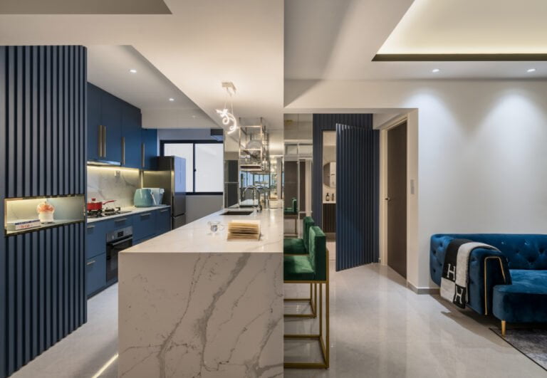 Contemporary kitchen with blue cabinets, marble island, green bar stools, and blue sofa in a sleek, contemporary design. Perfect for interior inspiration.