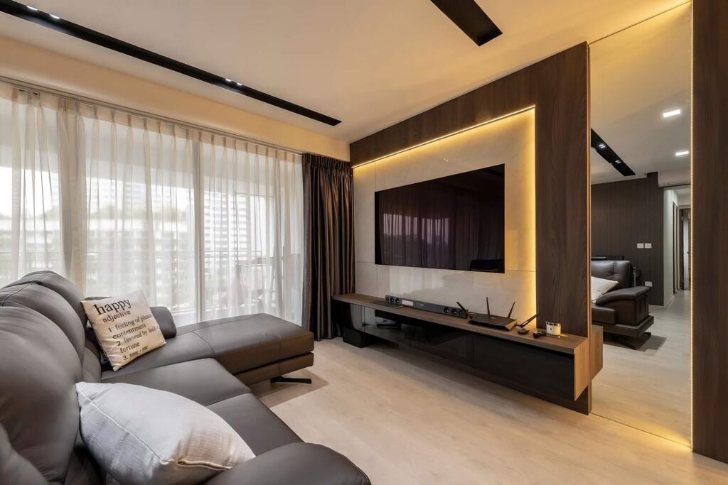 Contemporary living room interior with gray leather sectional sofa and marble-textured TV feature wall with ambient lighting.