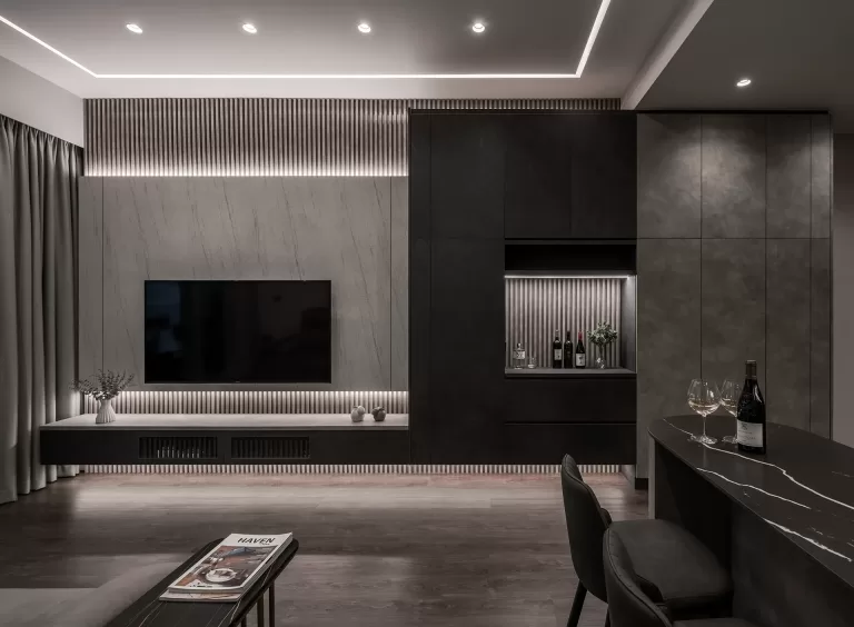Custom TV feature wall with vertical wood slats, floating console, integrated LED lighting, and built-in wine display cabinet in Hillview Rise condo renovation Singapore.