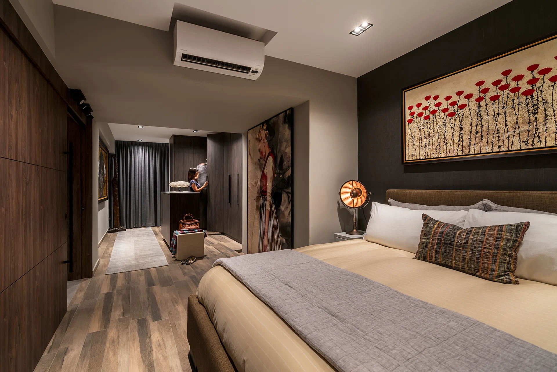 A modern HDB master bedroom at Bukit Purmei with red floral artwork above the bed, industrial floor lamp, and a warm, textured interior.