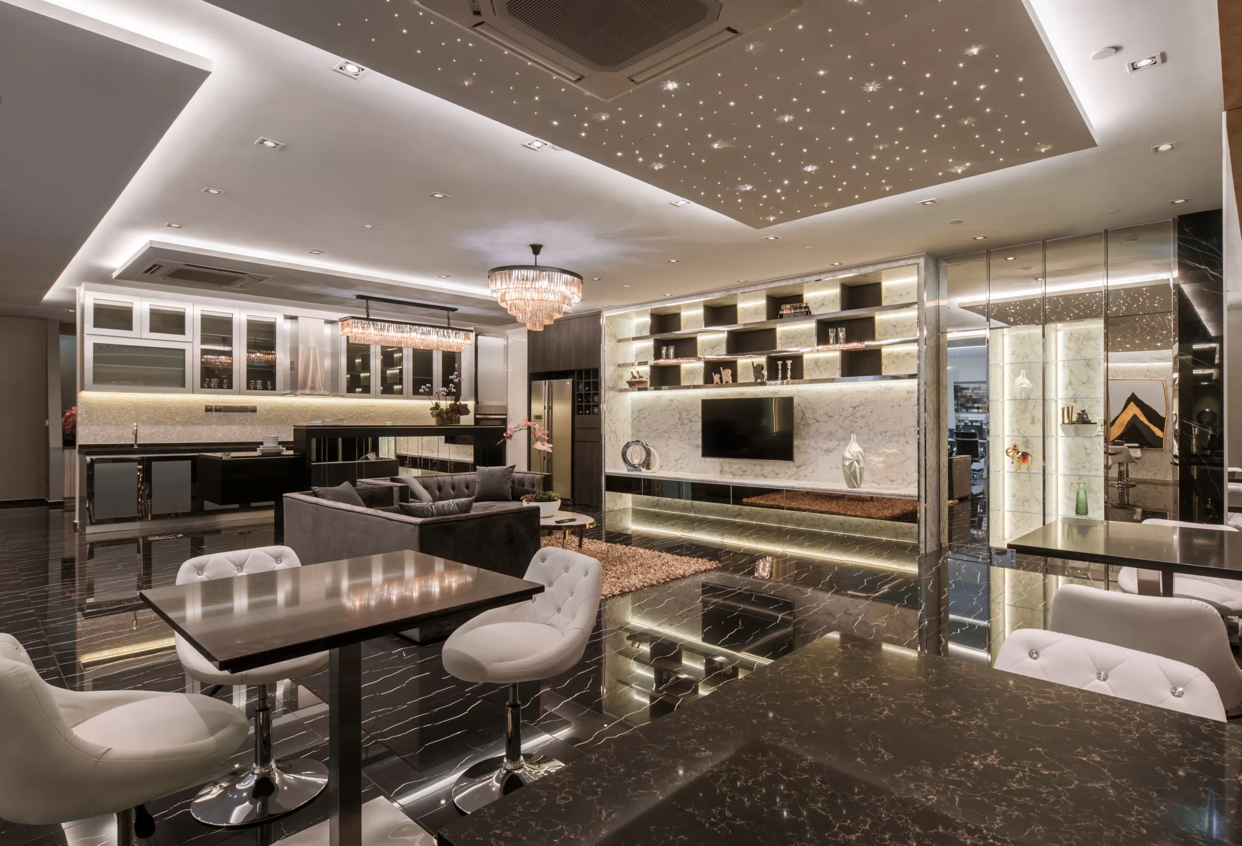 Luxurious modern office lounge and kitchen with marble flooring, stylish furniture, sparkling chandelier, and starry ceiling lights for high-end interior design inspiration at 37 Jalan Pemimpin.