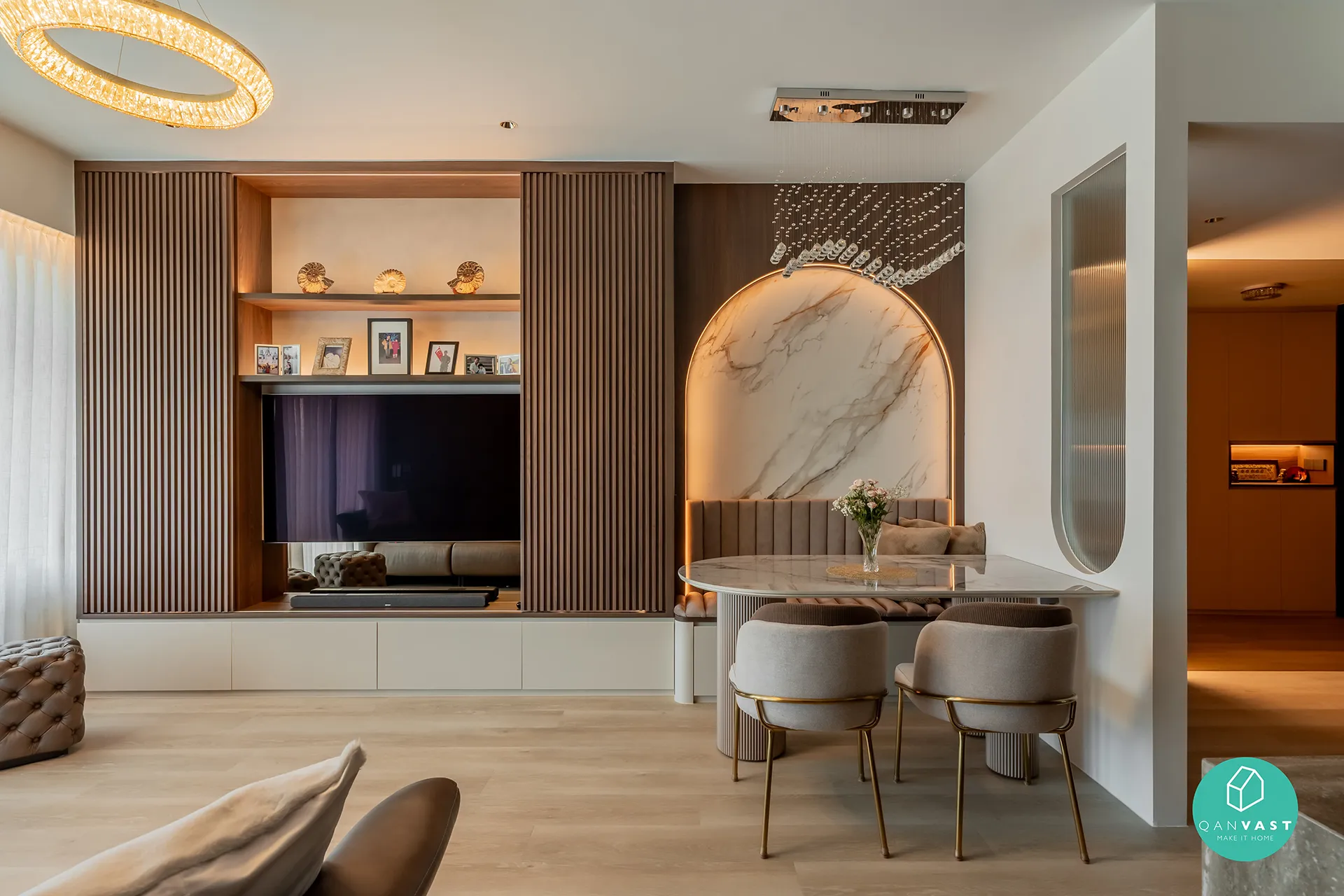 Open-concept living and dining space in One Pearl Bank, Singapore, with a TV wall featuring vertical wooden slats and a marble-topped dining table with a built-in bench.