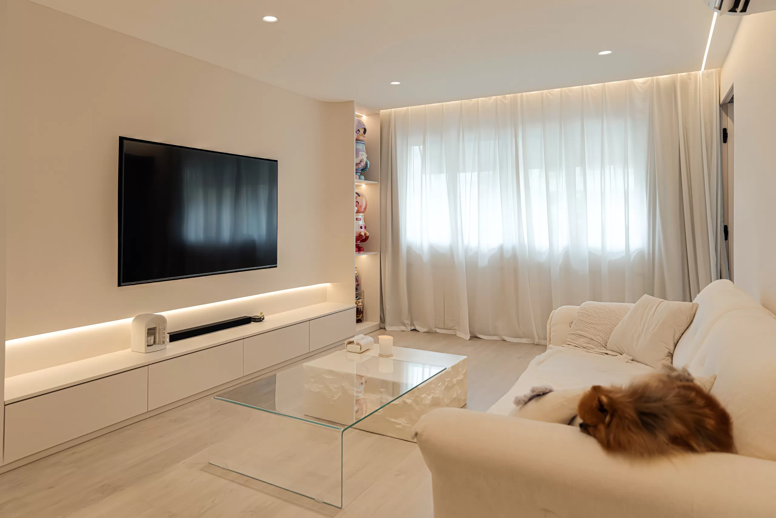 Serene Wabi-Sabi minimalist living room with a plush white sofa, a glass coffee table, and soft beige tones, creating a calm, comfortable environment in the HDB.