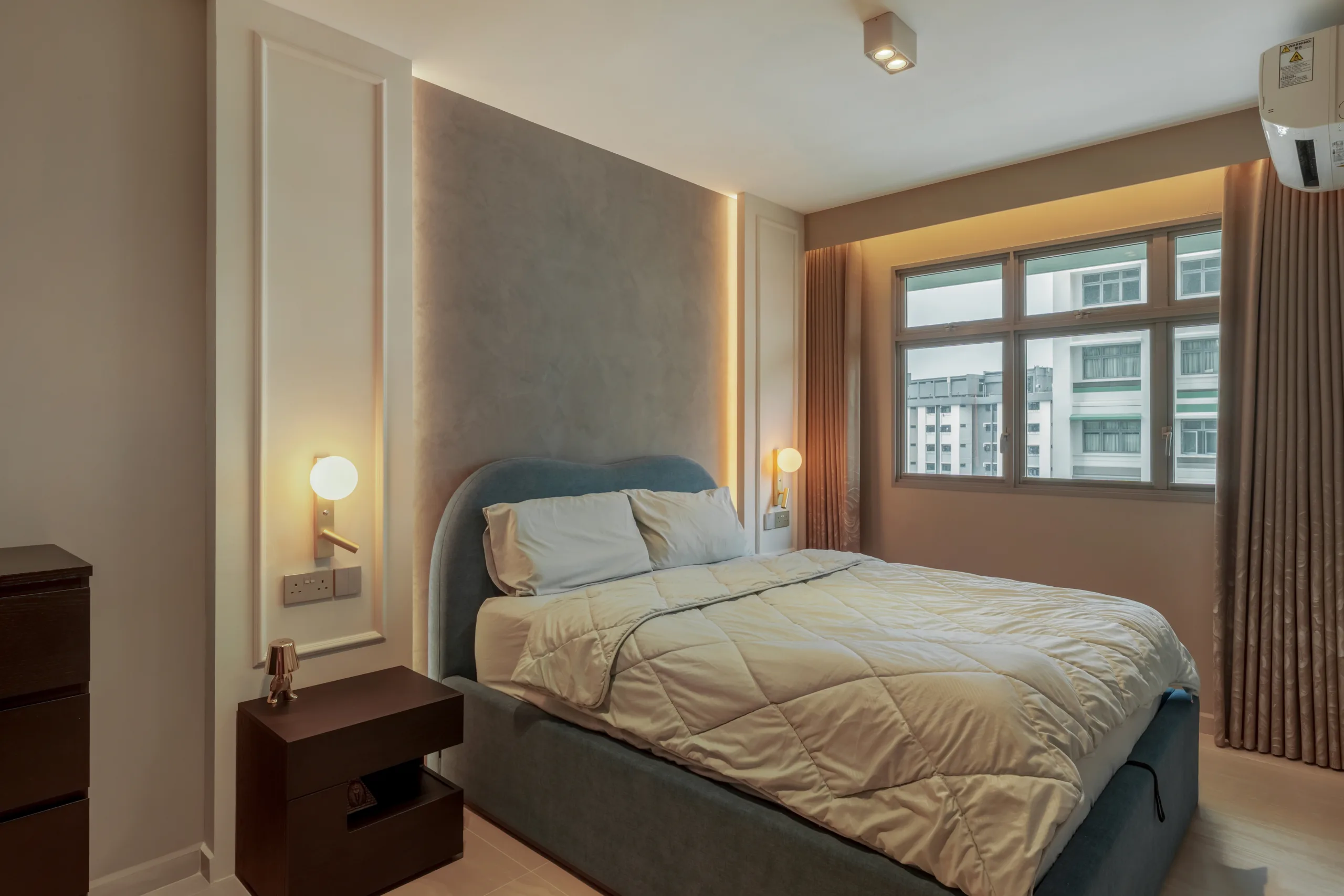 Cozy bedroom design with beige blackout curtains, spherical wall sconces, and soft neutral bedding.