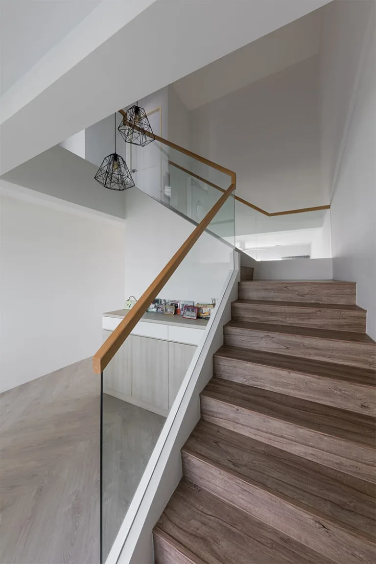 HDB maisonette staircase with glass balustrade, oak handrail and black cage pendant lights