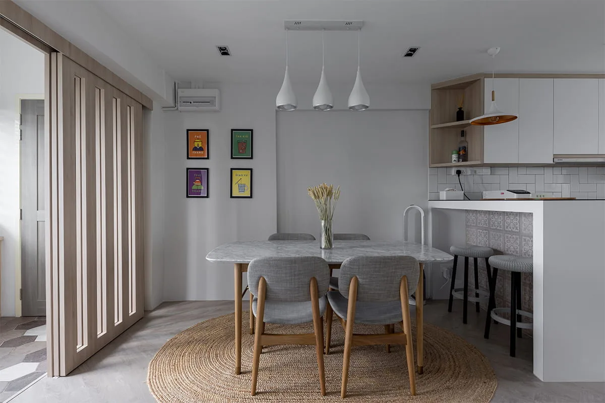 Maisonette dining area with marble-top table, jute rug and fluted timber sliding screen