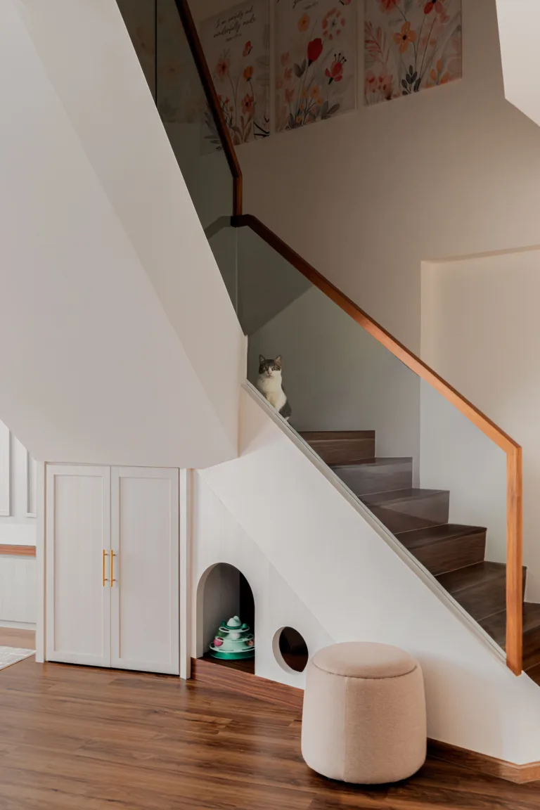 Glass balustrade staircase with an arched built-in cat house beneath