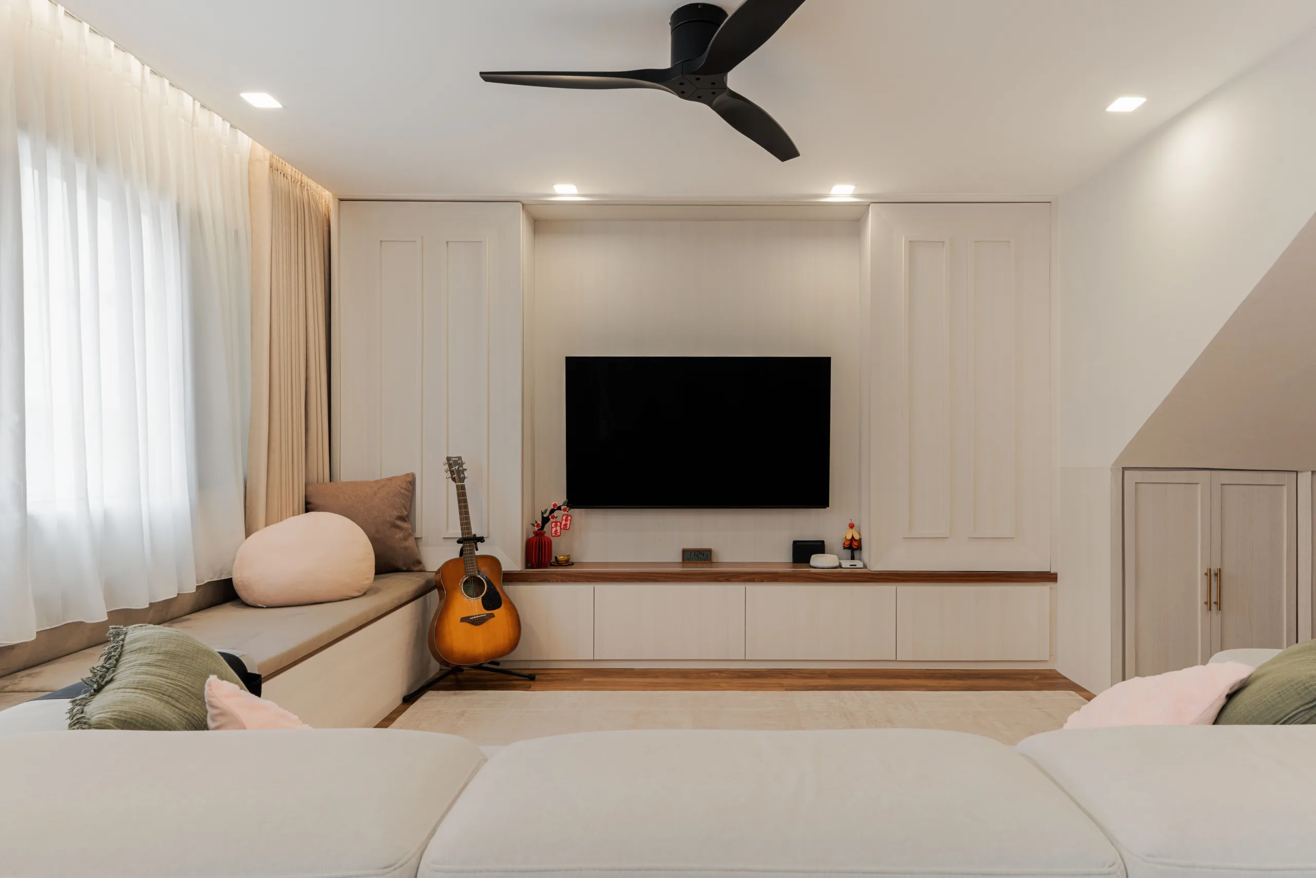 Sliding panels closed over the television, leaving a symmetrical panelled wall
