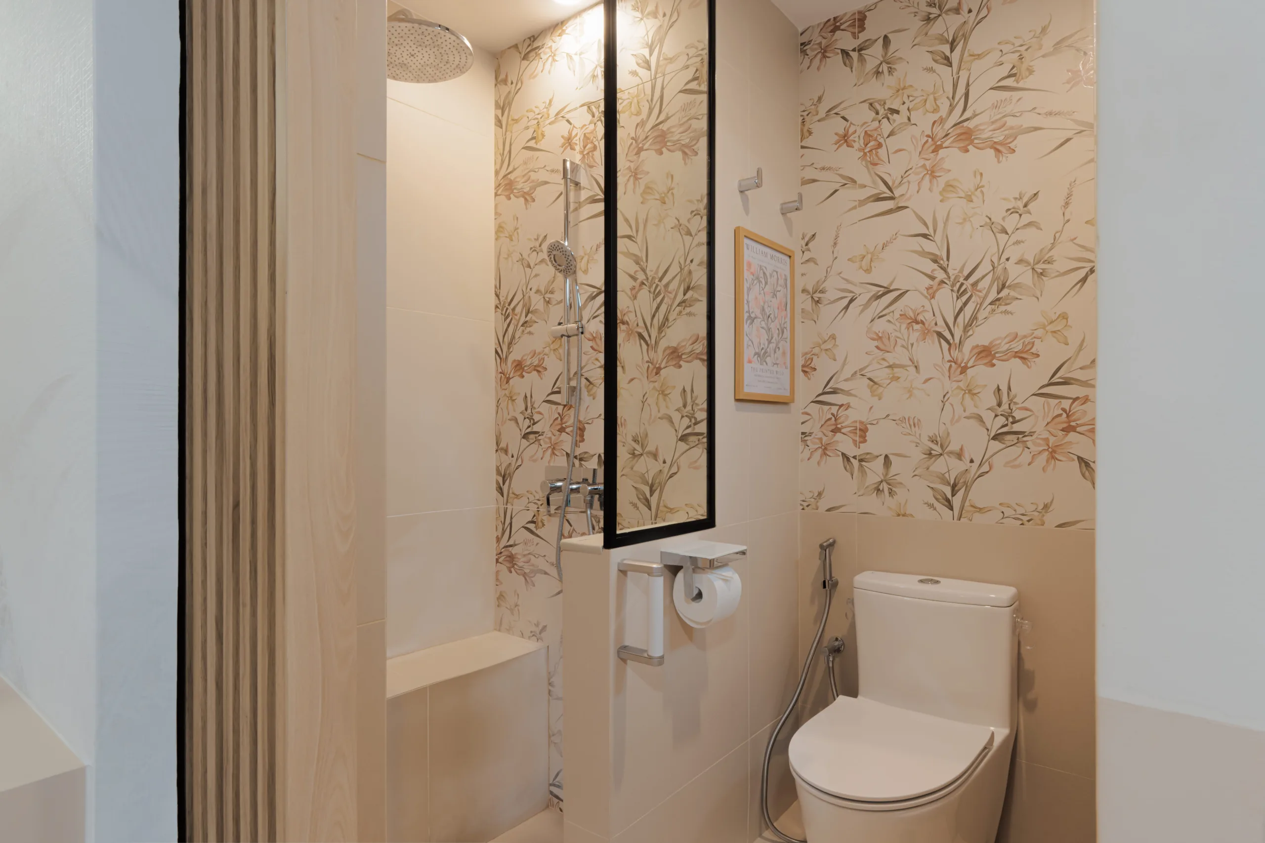 Bathroom at Watercolours EC with a built-in masonry shower bench, rain shower and handheld on a slider rail behind black slim-frame glass